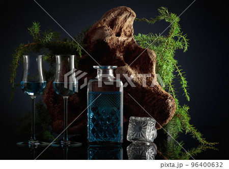 Blue gin and Juniper branches on a black background. Blue gin and Juniper branches on a black background. 96400632