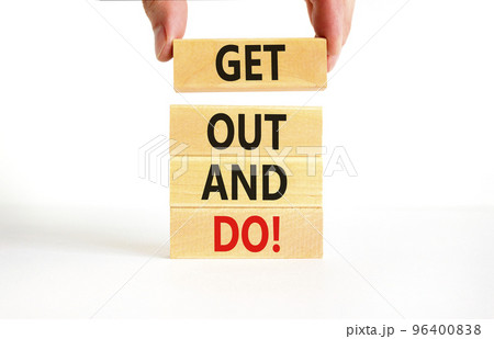 Motivational get out and do symbol. Concept words Get out and do on wooden cubes. Beautiful white table white background. Businessman hand. Business motivational get out and do concept. Copy space. 96400838