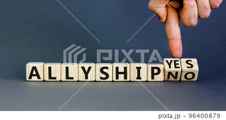 Allyship yes or no symbol. Concept words Allyship yes or Allyship no on wooden cubes. Businessman hand. Beautiful grey table grey background. Business Allyship yes or no concept. Copy space. Allyship yes or no symbol. Concept words Allyship yes or Allyship no on wooden cubes. Businessman hand. Beautiful grey table grey background. Business Allyship yes or no concept. Copy space. 96400879