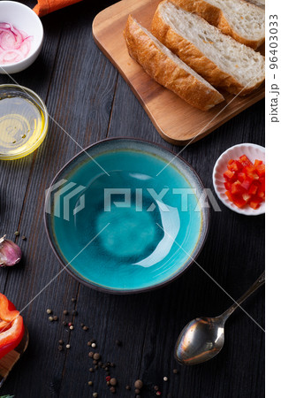 fresh ciabatta bread  with blue bowl and ingredients served at dark wooden table. meditarranean cuisine. flat lay 96403033