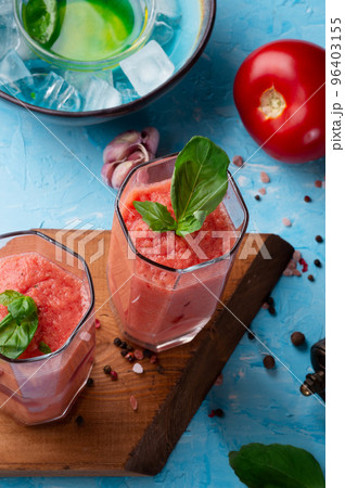 classic spanish raw eating cold soup Gazpacho served  in glasses around blue background. food recipe. healthy concept. 96403155