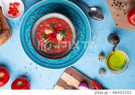 classic spanish raw eating cold soup Gazpacho served at blue  table. flat lay. food recipe. healthy concept. classic spanish raw eating cold soup Gazpacho served at blue  table. flat lay. food recipe. healthy concept. 96403202