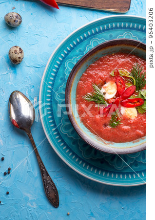 classic spanish raw eating cold soup Gazpacho with quail eggs served at blue  table. flat lay. food recipe. healthy concept. 96403206