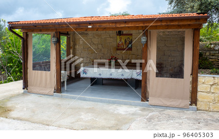 Gazebo for eating in the courtyard of a Christian Church in a mountain Village on the island of Cyprus. Gazebo for eating in the courtyard of a Christian Church in a mountain Village on the island of Cyprus. 96405303