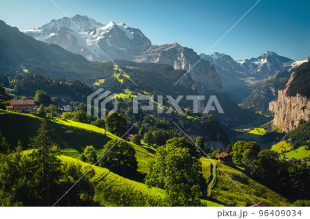 Majestic deep valley with waterfalls and green fields, Lauterbrunnen, Switzerland 96409034