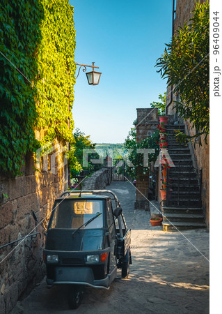 Parked small old vehicle in the narrow street, Italy 96409044