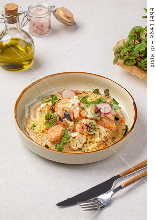 Portion of ptitim dish with seafood and herbs 96413494