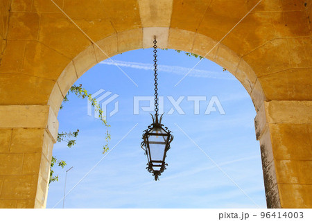 hanging lamp in a villa with blue sky and arch as background  96414003