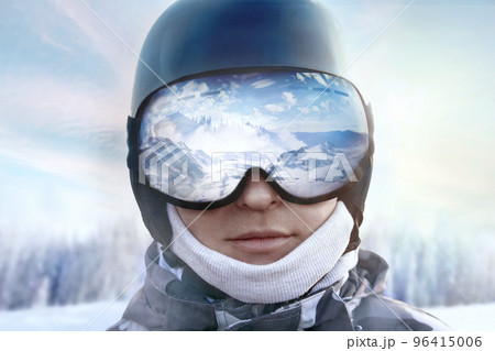 A mountain range reflected in the ski mask. Winter Sports.Wearing ski glasses. 96415006