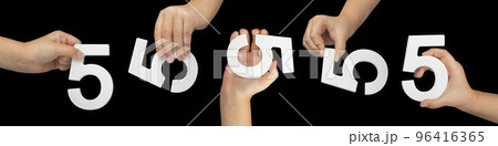 Number five in hand isolated on black background. Number five in the hand of a child holding on a black background. Large set of hands with numbers to insert into a project or design. 96416365