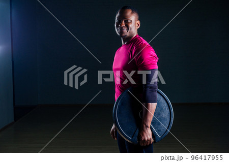 young african american man sportsman squatting sportsman exercising dumbbell T-shirt sports uniforms sport wear black background studio gym 96417955