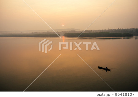 man in boat on the lake at sunset (dawn) man in boat on the lake at sunset (dawn) 96418107