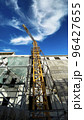 Tower building crane against the blue sky and sun. Construction of new buildings with a crane. Tower crane in Tbilisi, Georgia 96427655