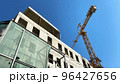 Tower building crane against the blue sky and sun. Construction of new buildings with a crane. Tower crane in Tbilisi, Georgia 96427656