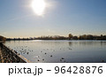 Sun in eclipse near river 96428876