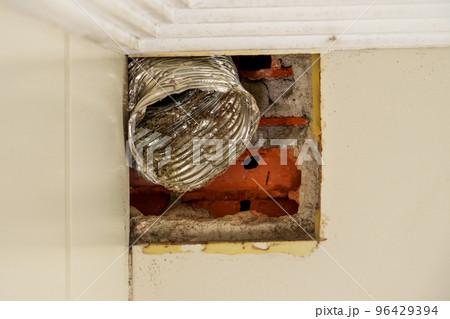 Damaged broken corrugated ventilation pipe with dust and dirt inside in the bathroom. Technical maintenance service concept Damaged broken corrugated ventilation pipe with dust and dirt inside in the bathroom. Technical maintenance service concept 96429394