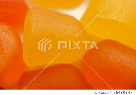 Close-up texture of orange and yellow multivitamin gummies on white background. Healthy lifestyle concept Close-up texture of orange and yellow multivitamin gummies on white background. Healthy lifestyle concept 96430347