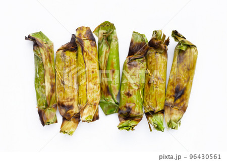 Grilled sticky rice in banana leaves with banana filling 96430561