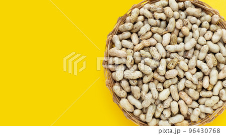 Raw peanuts on yellow background. Raw peanuts on yellow background. 96430768