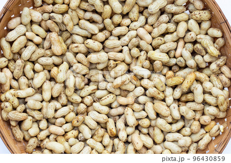 Raw peanuts in bamboo basket on white background. 96430859