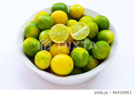 Fresh limes in white bowl 96430961