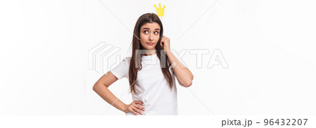 Entertainment, fun and holidays concept. Portrait of sassy and classy good-looking girl in t-shirt, holding carnaval stick with crown, acting like queen or super star, standing white background 96432207