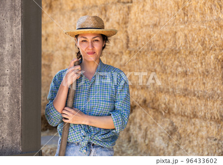 Asian woman farmer resting on hayloft 96433602