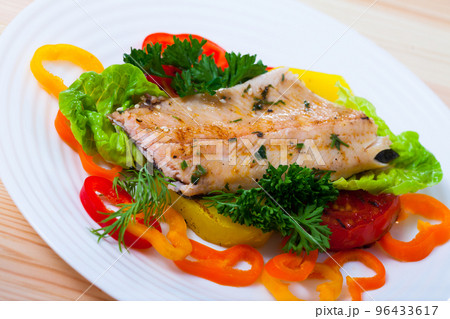 Fillet of trout with vegetables and greens 96433617