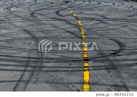 Tire track mark on asphalt tarmac road race track texture and background, Abstract background black tire tracks skid on asphalt road in racing circuit, Tire mark skid mark on asphalt road. 96434252