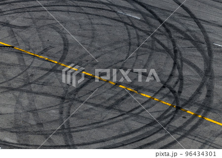 Tire track mark on asphalt tarmac road race track texture and background, Abstract background black tire tracks skid on asphalt road in racing circuit, Tire mark skid mark on asphalt road. Tire track mark on asphalt tarmac road race track texture and background, Abstract background black tire tracks skid on asphalt road in racing circuit, Tire mark skid mark on asphalt road. 96434301