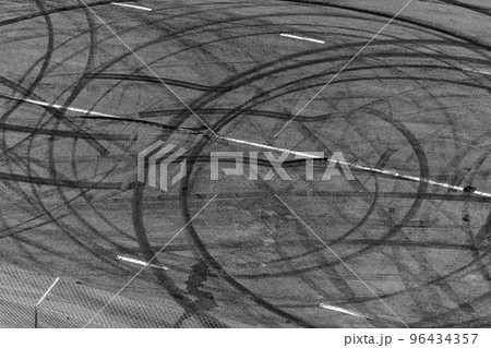 Top view tire tracks texture and background, Asphalt texture with line and tire marks, Automobile automotive tire skid mark on race track, Abstract texture car drift tire skid mark. Top view tire tracks texture and background, Asphalt texture with line and tire marks, Automobile automotive tire skid mark on race track, Abstract texture car drift tire skid mark. 96434357