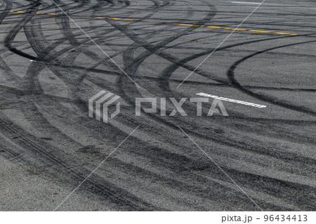 Tire track mark on asphalt tarmac road race track texture and background, Abstract background black tire tracks skid on asphalt road in racing circuit, Tire mark skid mark on asphalt road. 96434413