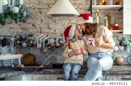 family in the kitchen decorating for Christmas 96439121