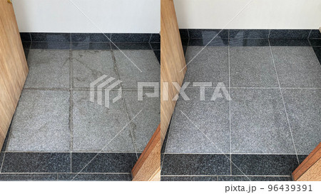 Before and after cleaning on an old gray granite entryway floor 96439391