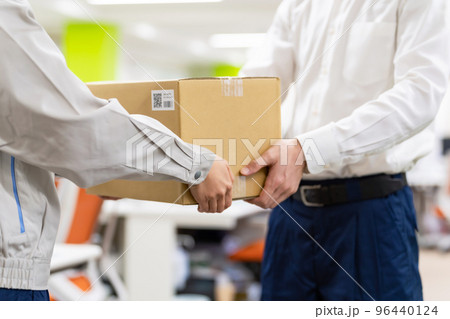 荷物を受け渡す作業員 96440124