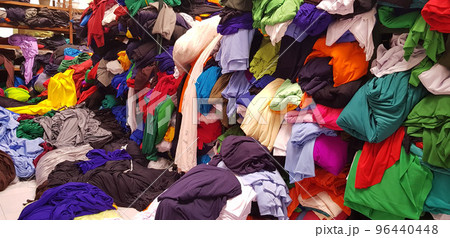 multi colored pile of fabrics, fabric for sewing clothing, fashionable fabric and textile multi colored pile of fabrics, fabric for sewing clothing, fashionable fabric and textile 96440448