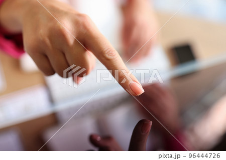 Female hand pointing with finger on tablet screen 96444726