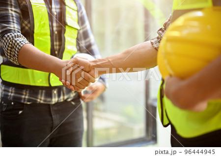 Professional construction engineer or worker shaking hands with his coworker. close-up 96444945
