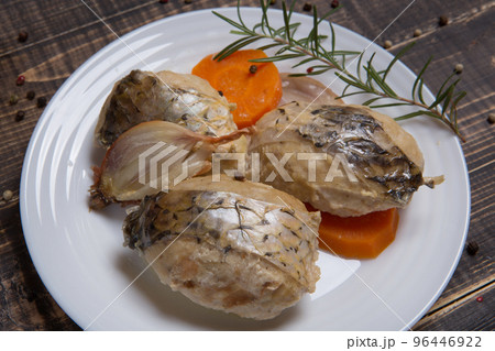 Fish meatballs with carrots and onions, garnished with a sprig of rosemary, on a white plate Fish meatballs with carrots and onions, garnished with a sprig of rosemary, on a white plate 96446922