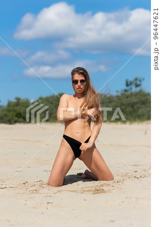 Sexual woman in bikini panties on beach Sexual woman in bikini panties on beach 96447621