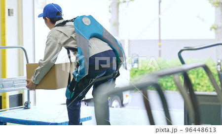 倉庫でパワーアシストスーツを使う作業員 倉庫でパワーアシストスーツを使う作業員 96448613