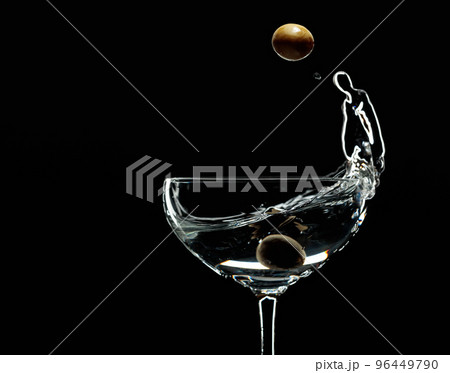 Silhouette of martini with green olives on a black background. 96449790