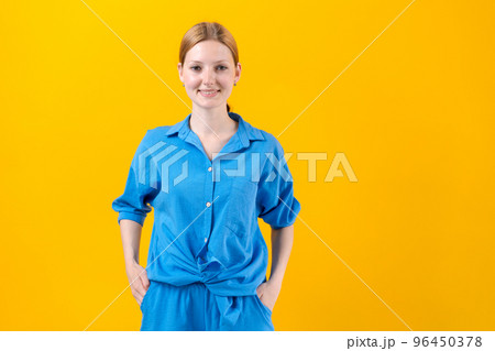 Studio portrait beautiful young woman thinking and looking at camera, wearing 96450378