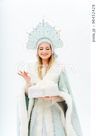 portrait of Snow Maiden in a costume with a kokoshnik with gift box on a white. 96452429