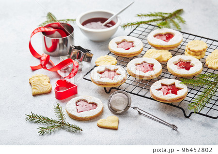 Classic Linzer Christmas Cookies with raspberry or strawberry jam on light background. 96452802