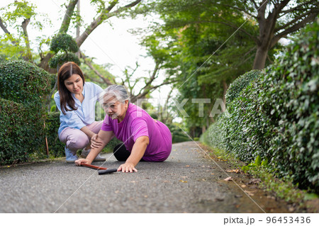 Asian senior woman fell down on lying floor because faint and limb weakness and Crying in pain form accident and her daughter came to help support. Concept of old elderly insurance and health care 96453436