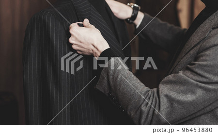 Tailor working on custom made suit 96453880