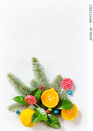 Fresh and Juicy Tangerines, Spruce branches, Snow, and a variety of Christmas sweets on stone or concrete table. Fresh and Juicy Tangerines, Spruce branches, Snow, and a variety of Christmas sweets on stone or concrete table. 96455862