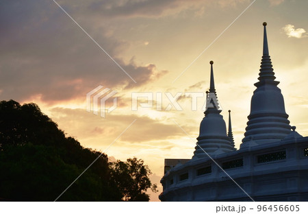 white pagoda on sunset at Wat Prayurawongsawas Warawihan in Thailand 96456605