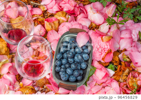 Wine glasses with blueberry in rose garden. 96456829